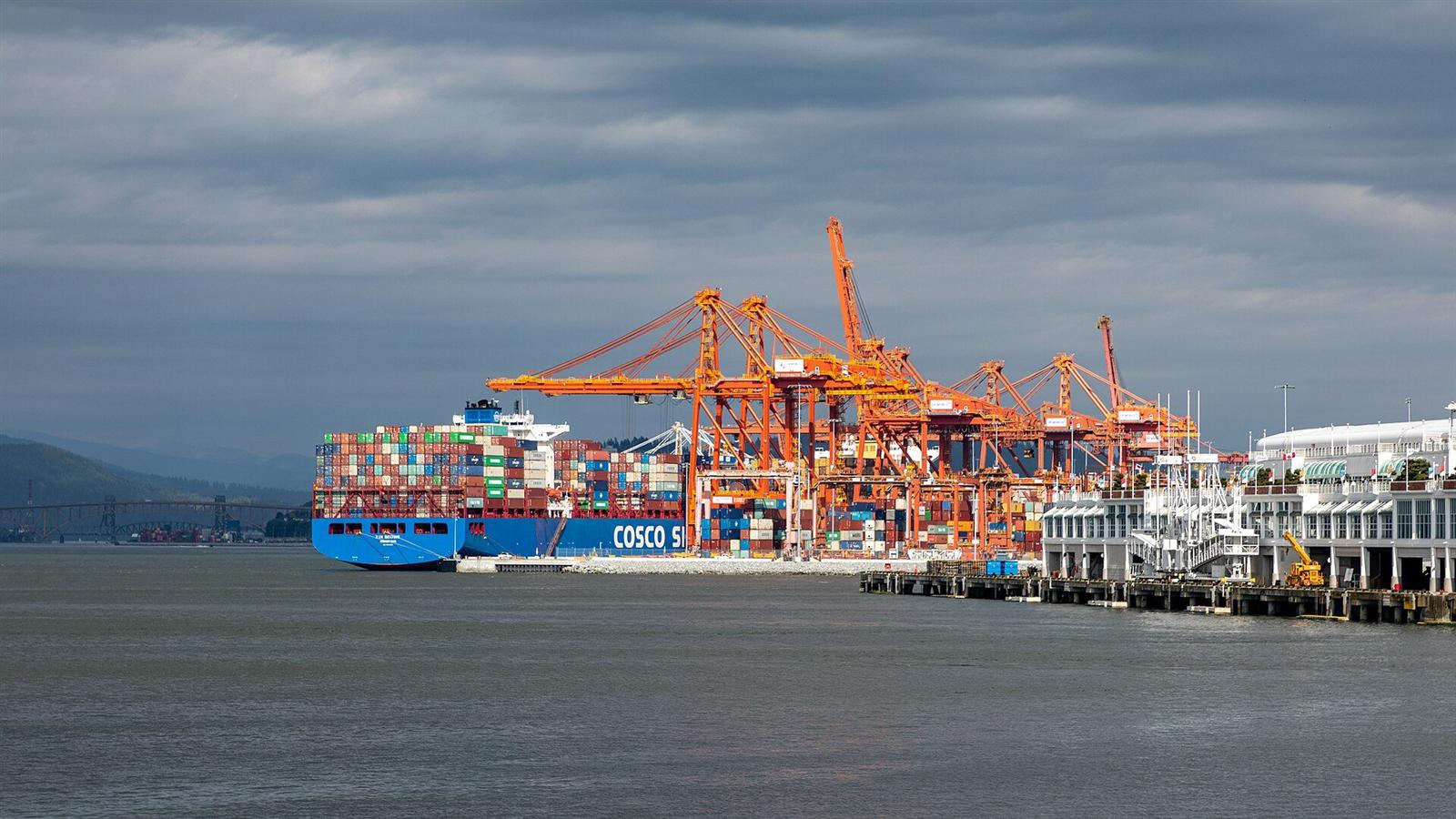Container ships, cranes and cargo at Vancouver Centerm Terminal in British Columbia