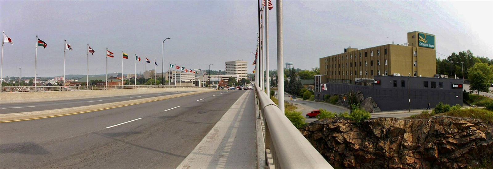 National flags lining the Bridge of Nations toward downtown Sudbury